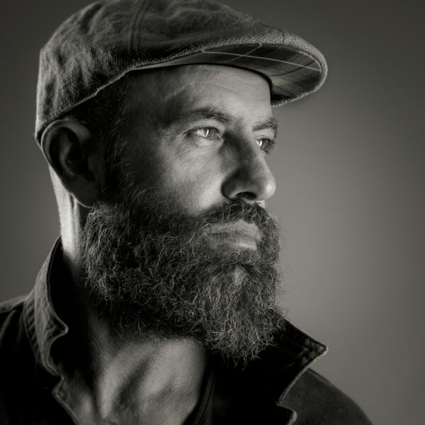 a black and white photo of a man with a beard